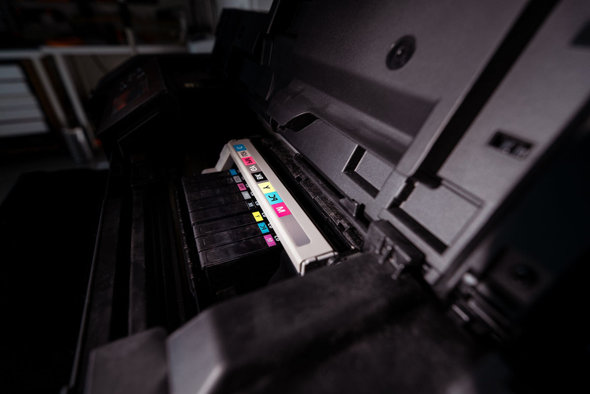 Open printer showing its colour cartridges